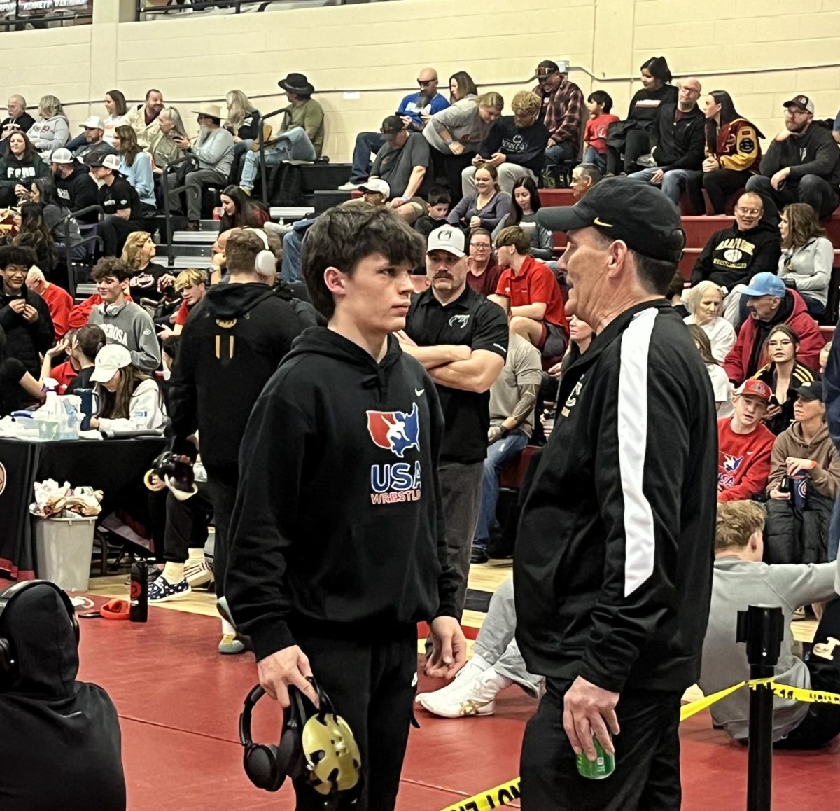 Varsity wrestling captain and state qualifier Noah Jadd ‘26 talks to former Jags wrestling coach, Tim Hill, before wrestling his final match of the regional tournament at Ponderosa High School Feb. 10. Jadd lost by fall in two minutes and 20 seconds to Ponderosa wrestler Jacob Myers ‘24 and placed second overall in the tournament. Jadd will compete at State at Ball Arena from Feb. 15 to Feb. 17. “It was surreal,” Jadd said. “[It was] a great feeling knowing that all of my work paid off. At some points, I questioned myself, doubting if I was good enough. There was a lot of pressure to make it [to] State, but the feeling of pinning my opponent was great, knowing that I made it.”