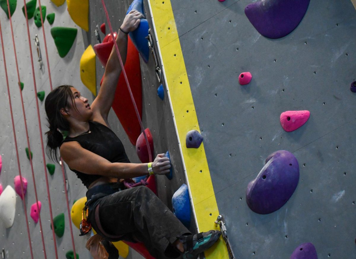 On Feb. 24, Emerson Yu ‘24 climbs a roped route during the girls’ varsity competition. Participants had three hours to complete a total of five routes: two roped, two bouldering and one of their choice. “I started climbing about a year and a half ago,” Yu said. “I didn’t start competing until my senior year, which I kind of regret because I love it so much. The rock climbing community is great.”