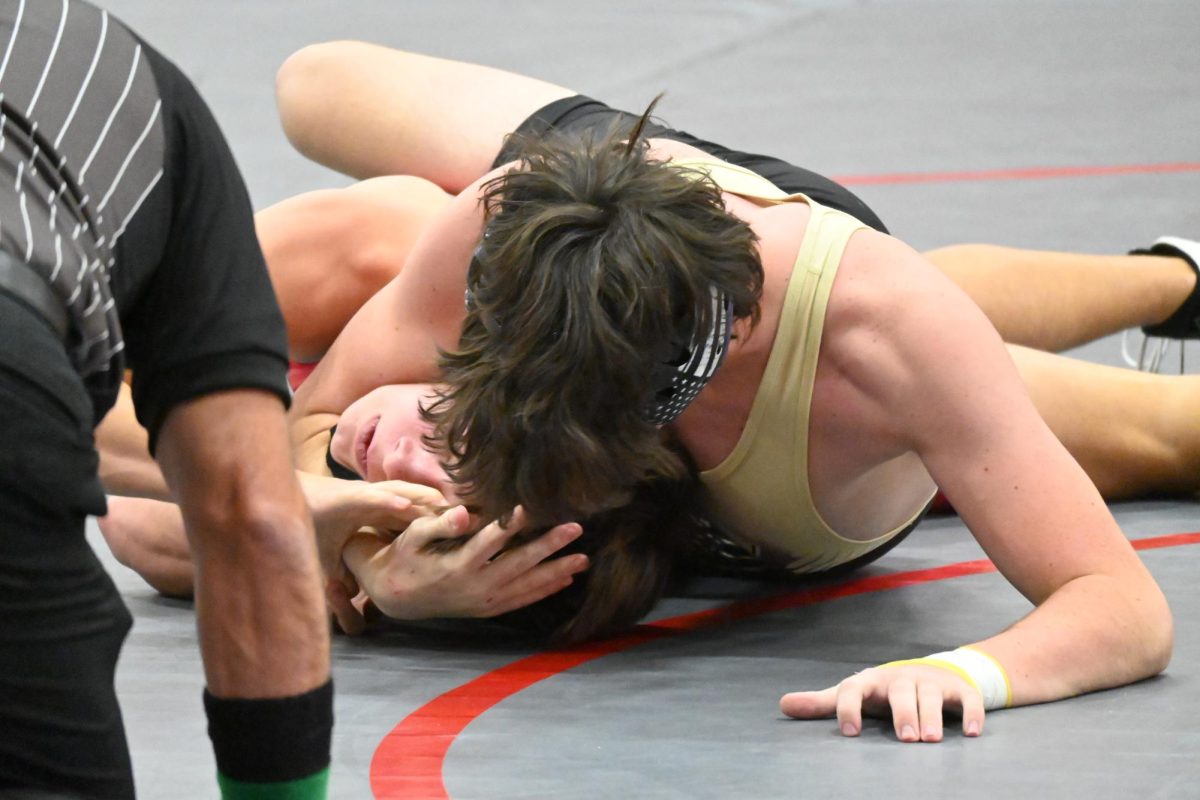 Bodey Sherill ‘24 pins Max Garcia during his match against the Heritage Eagles Jan. 17. Sherill won by pin in five minutes and 34 seconds. “I knew I had more technical experience and endurance than he did. I knew if I kept that in mind, I’d beat him,” Sherill said.