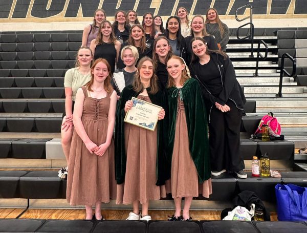 At Prairie View High School, the winterguard team poses with their plaque after winning first place at their competition Feb. 24. This was the second time they won first place this year, this time with a score of 74.190 points. “I [love being] a witch, but my favorite [part of the show] is the trios, it’s so cool,” Heather Strickland ‘27 said.