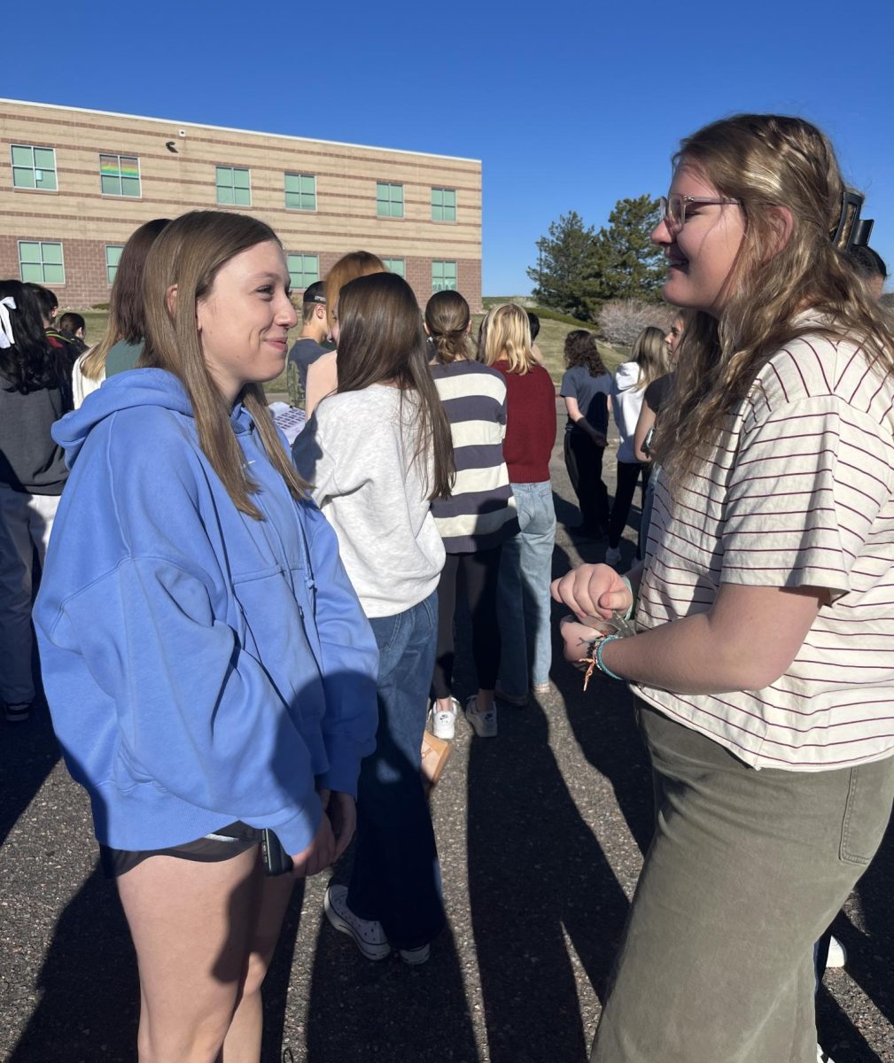 Caroline Watts ‘26 and Camille Olsen ‘26 stand outside after evacuating the building during an unplanned safety evacuation April 9. While in fifth period around 8:30 a.m., the fire alarm went off due to the steam from the kitchen dishwasher triggering the fire sensors. “It was actually a nice break from classes and we got to go outside,” Olsen said.