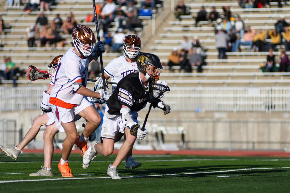 During a game against Legend High School April 9, attack Aidan Brock 24 runs toward the goal at EchoPark Stadium. The Jaguars were ahead at first, but ended up with a score of 9-6 L. Brock scored two goals during this game.