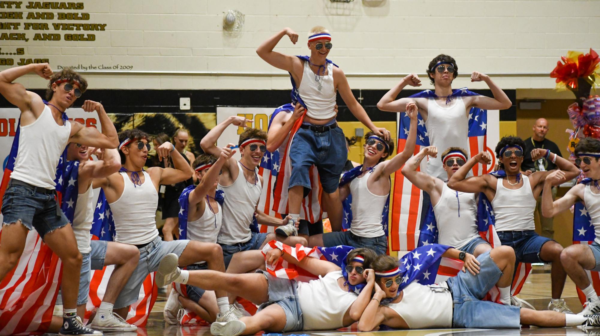 Man Poms poses at the end of their routine in the gym during the Homecoming Assembly Sept. 19. Man Poms is an annual tradition in which boys from the senior class perform at both the Homecoming Assembly and the Homecoming football game. “I joined Man Poms because it sounded fun and a lot of my friends were doing it, so I went ahead and joined. Also performing in front of the whole school sounded amazing,” Man Poms dancer Nidhay Somanchi ‘25 said. “My favorite part of performing was hyping up the crowd at the football game and at the assembly because it shows our connections with each other and our crazy school spirit.”
