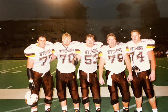 (middle) Rob Rathbun, #53, poses with his fellow linemen at the University of Wyoming. 