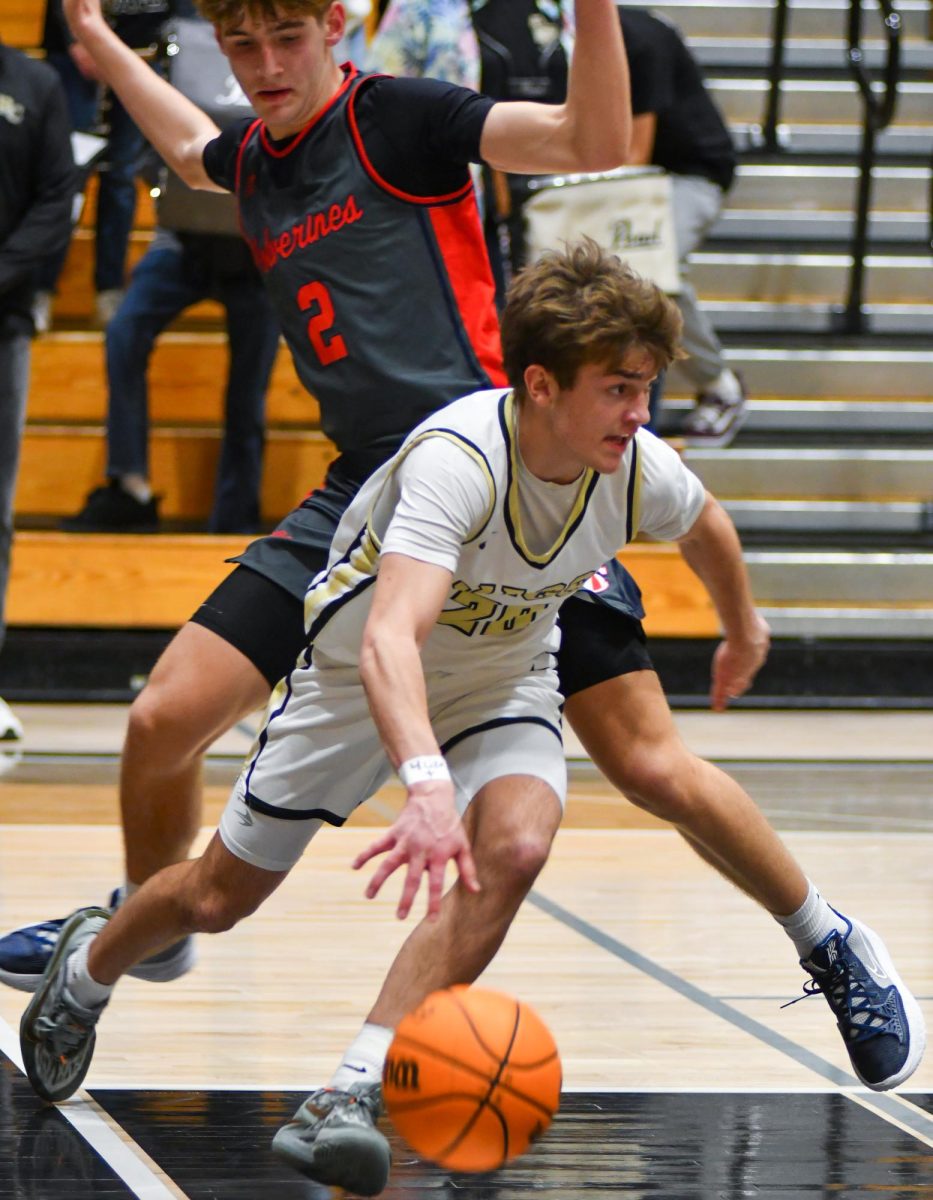 Varsity Point Guard Cooper Ellwood ‘27 rebounds the ball against ChaparralWolverines Jan. 24 at 7 p.m. During this season, Ellwood averages two steals per game. “I totally feel ourselves coming together as a team, we keep improving every day in practice and I think there are bright things ahead,” Ellwood said. 