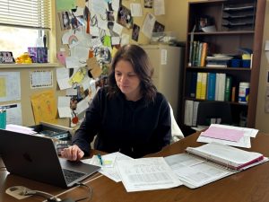 Discrete Math/Prob & Stat, Geometry and Algebra 1 math teacher Rachel Carmody grades her fourth period students’ quizzes during access Feb 11. Carmody has been teaching for 19 years in total, but she started here in 2019-2020 during the pandemic. “I don’t take it personally if someone doesn’t like math, it's not everybodys’ jam,” Carmody said.