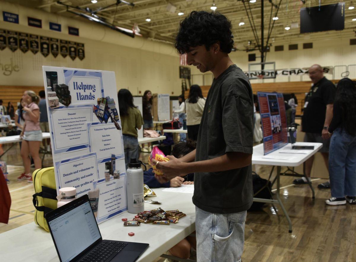 Minutes before the Activities Fair in the gym, president Abhi Gowda ‘26 prepares the stall for his club Helping Hands, Sept. 4. A relatively new club, Helping Hands was co-started by Gowda and focuses on assisting the homeless, and just last year they succeeded in raising a couple hundred donations to send to shelters. This year, they have goals to expand, with hopes to increase volunteer opportunities and take in-person trips to shelters, as well as extend their help beyond just homeless people. “The Activities Fair gives a lot of underclassmen the opportunity to really get to know the Canyon culture, and it gives them many opportunities for service and volunteering,” Gowda said. “[Through the Activities Fair,] I hope to find a bunch of new and passionate members about our club and just get our name out there and spread awareness to the cause that we’re fighting for.” 